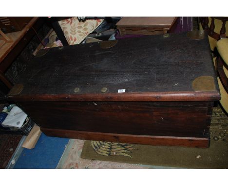 A large Oriental hardwood Trunk with metal plates and studs, ornate brass hinges, of dovetail construction. 50 3/4" wide x 21