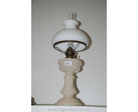 An Oil Lamp with opaque glass base and reservoir with white shade.
