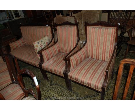 An Edwardian Mahogany show frame three piece Salon Suite comprising two seater sofa and two armchairs in salmon pink ground R