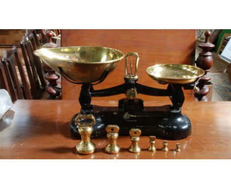 A Cast Iron Weighing Scales by Libra Scale Co. of England "Librasco" with 6 weights and original brass trays.