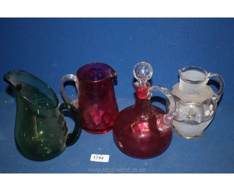 A Cranberry Decanter and Jug together with green and white blown glass jugs, etc.