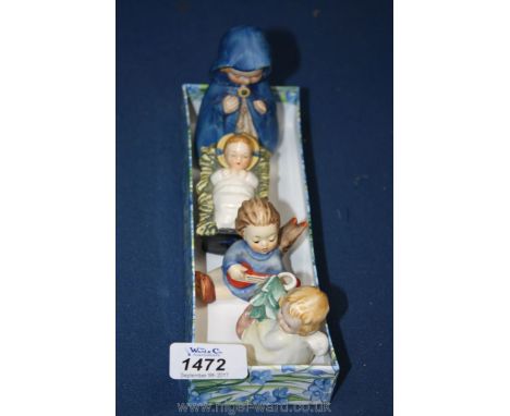 A small Goebel child in a crib, a Goebel Mary in a blue cloak 4" tall and two small Goebel angels, one a candle holder with t