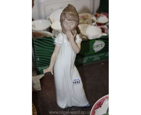 A Nao figurine of a young Lady preparing for bed