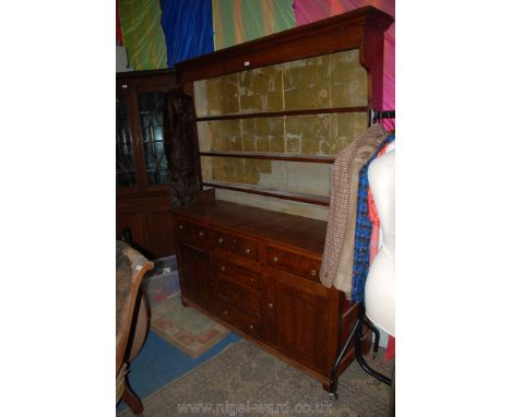 A Victorian Oak, country made Dresser with plate rack, the rack with moulded top and three shelves having wide, painted back 