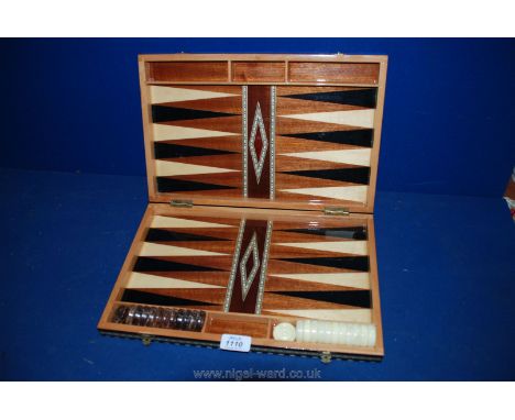 A folding Draughts and Backgammon Case with draught counters