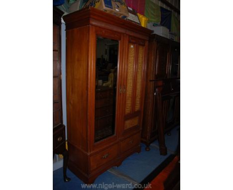 An Edwardian Satinwood two door Wardrobe with cornice over bevel plated mirrored door and three burr panel door over two burr
