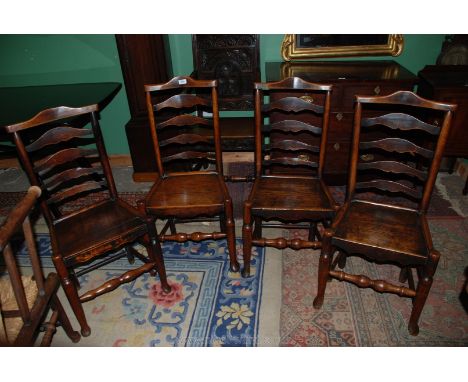 A set of four Ash and Elm ladder back Clissett style Dining Chairs, having solid seats, on turned and shaped front legs.