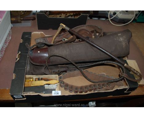 Two canvas gun sleeves, a cartridge belt, hunting whip (as found) and sharpening stones