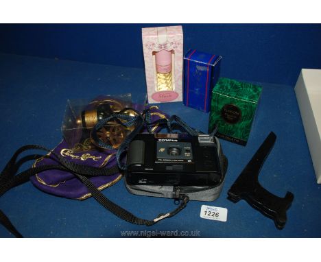 A cased Olympus Camera, Poison eau de toilette by Christian Dior, Joie de Vivre spray, Musk spray and a small canon of Cognac
