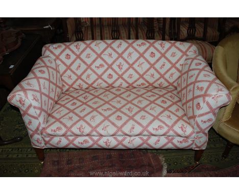 A small two seater, single drop arm Sofa, upholstered in white ground with animal print fabric, on tapering square legs and b