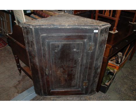 A Georgian Oak wall hanging Corner Cupboard, having single panel door with ornate iron hinges and three shaped shelves. 35" w