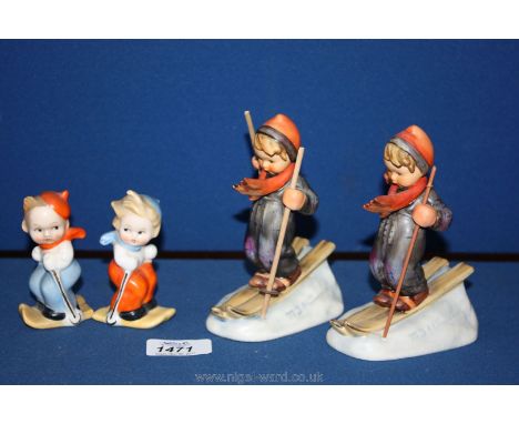 A pair of Cruets depicting skiers 3 1/2" tall together with two M.J. Hummel children on skis 5" tall (skis a/f)