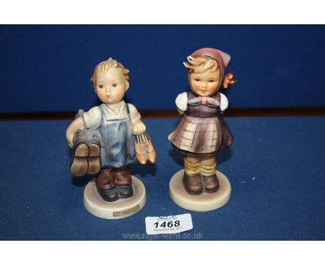 A Goebel 'Boots' figurine together with a Goebel figurine of a girl in a checked dress