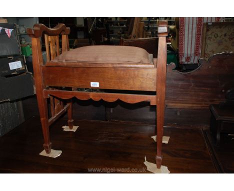 An Art Nouveau light Mahogany Piano Stool with shaped handles, upholstered seat, pierced slatted sides, on square legs termin