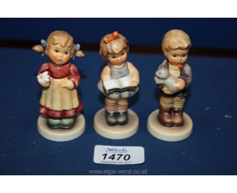 A Goebel girl reading a book 3 1/4" tall, a Goebel figure of a girl with a flower 3 1/4" tall and a little boy holding a rabb