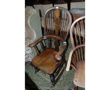 A 19th c. splat and stick back Elm seat Rocking Chair with spindle turned supports, on turned legs and stretchers.