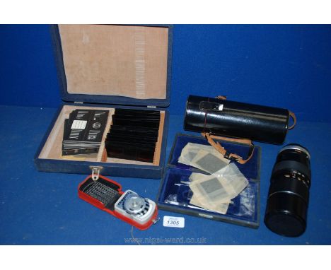 A large Panagor cased lens, light meter, box of nude stereo slides and microscope grids.