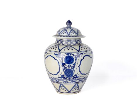 A BLUE AND WHITE PORCELAIN JAR AND COVER
Decorated with flowers and shaped oval reserves within geometric borders
34cm high
C