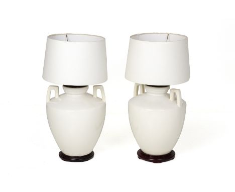 A PAIR OF WHITE PORCELAIN TABLE LAMPS Of twin handled urn form, with shades 74cm high including shadesTested working
Conditio