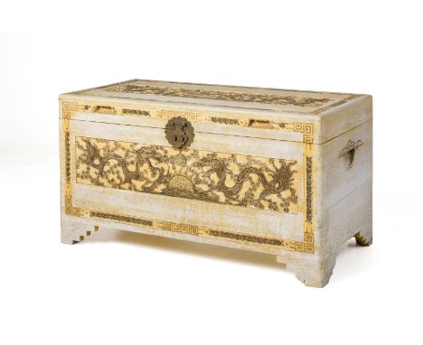 A CARVED TEAK TRUNK
With bleached finish, carved with panels of dragons chasing pearls, on stepped bracket feet
57cm x 102cm 