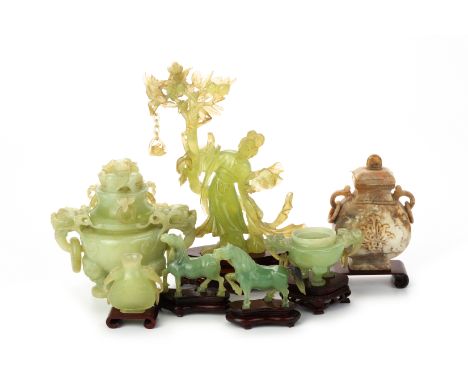 A GROUP OF JADE / SERPENTINE AND STONE CARVINGS Comprising; an elegant female figure beneath a fruiting peach tree; a twin ha