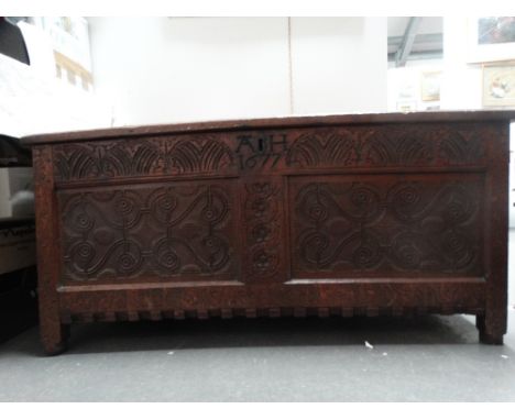 17th century oak coffer - A two panel coffer with dowel joints, carved and branded 'AH 1677' with lunettes and decoration ind