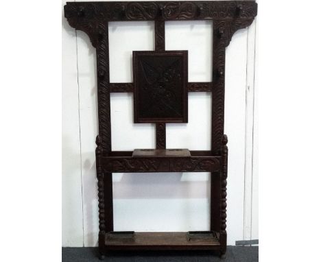 Victorian oak hallstand - A carved oak nine hook coatstand with umbrella stickstand, with glove box, decorated with dolphins 