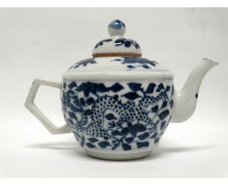 Chinese blue and white dragon teapot - A four toed Chinese blue dragon amongst leaves, height 10cm, length 14.5cm.