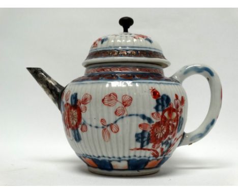 Japanese teapot - A ceramic and white metal mounted teapot in the Imari palette, decorated with a Greek key collar, repeated 