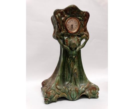 Art Nouveau ceramic cased clock - Green glazed and marked G 1914 within, having a figure in a diaphanous dress with floral mo