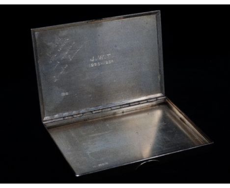 Cartier - A silver engine turned cigarette case, with yellow metal push clasp and sprung piano hinge, opening to reveal monog