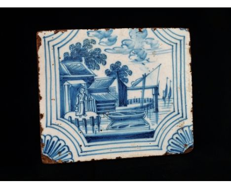 Delft - A blue and white tile depicting a figure at the water's edge, 10.5 x 13cm. 