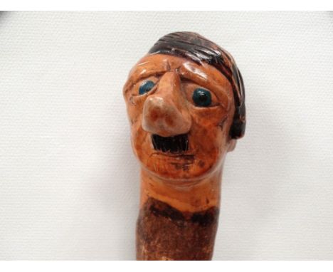 MILITARIA - World War Two (WWII) Folk Art - A carved ash stick with pommel formed as a caricature of Adolf Hitler. Formerly f