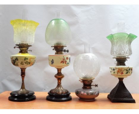 19th century oil lamps - A collection of six assorted glass reservoired oil lamps, some with brass columns, one with a malach