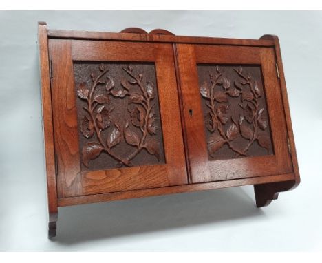 19th century walnut hanging cabinet - A two door carved cabinet, opening to reveal a shelf within, height 55.5cm, width 61cm,