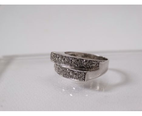 An 18ct white gold ring set diamond chips, size M/N.