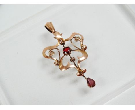 Art Nouveau - A 9ct gold pendant with brilliant cut ruby, diamonds and pear cut ruby, length 4.7cm, width 2.5cm. 