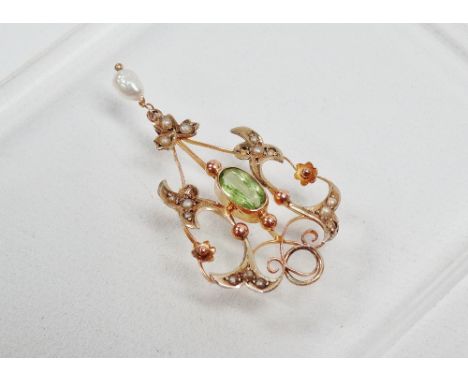 Art Nouveau - A 9ct gold pendant with oval facet cut peridot, diamond chips and baroque drop pearl, height 4.5cm, width 2.3cm