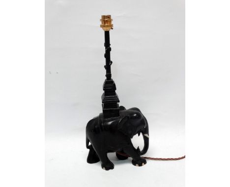 Ebony table lamp - A carved elephant with square pagoda style top section with shaft, height 40cm, length 17cm. 