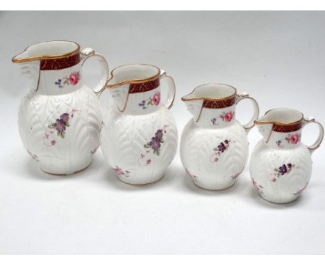 Coalport jugs - A set of four graduated jugs, 'The Caughley Mask-Head Jug', gilt and floral decorated with mask decoration to