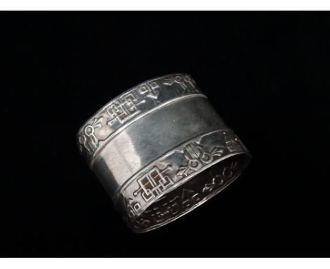 A Russian silver napkin ring decorated with two bands of geometric pattern, weight 48.5g.