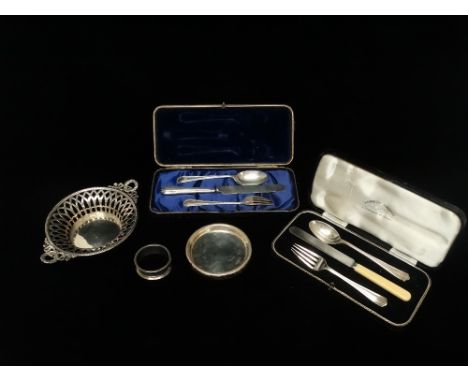 A pierced twin handled silver basket, with lancet shaped piercings, beaded rim, laurel chaplet and ribbon handles, Birmingham