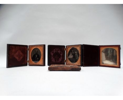 A sixth-plate daguerreotype of a seated lady, gilt highlights, in folding morocco case; two sixth-plate ambrotype portraits: 