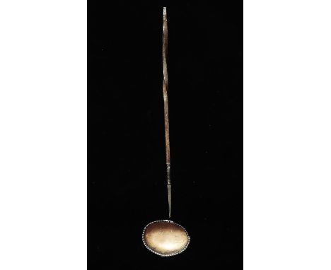 A silver toddy ladle with baleen handle, length 34cm.