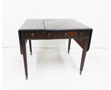 Mahogany sofa table with two frieze drawers with bun handles, raised on square tapering supports with brass caps and castors 