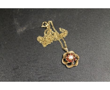 A HALLMARKED 9 CARAT GOLD RUBY AND SEED PEARL PEDANT 2.4G APPROX