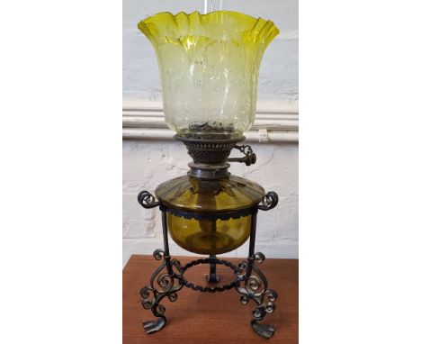 An oil lamp with yellow glass shade.&nbsp;The shade is in excellent original condition.