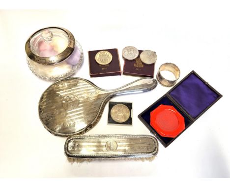 A silver backed hand mirror, together with a silver backed brush, a silver mounted glass powder jar, a silver napkin ring, a 