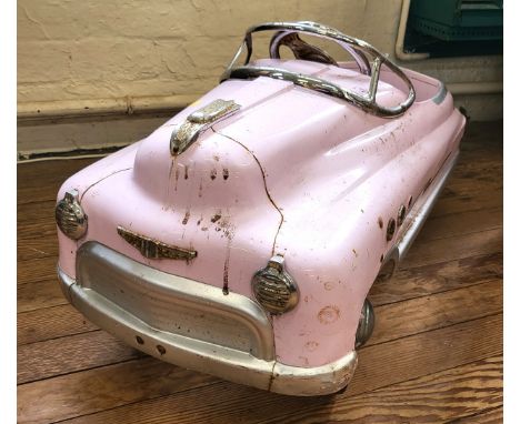 A children's toy Super Sport pedal car in pale pink, of retro design. 45cm x 96cm x 43cm. 