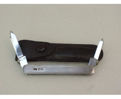 A double blade pocket knife of petite form having a silver engine turned case, Sheffield 1937, Needham Brothers Ltd, in a lea
